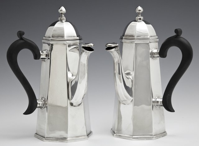 Near Pair of English Sterling Chocolate Pots,: Near Pair of English Sterling Chocolate Pots, Sheffield, 1938, by Walter and Charles Sissons, of tapered octagonal form with ebonized wood side handles and animal form spouts, Wt. with handles- 28.85 