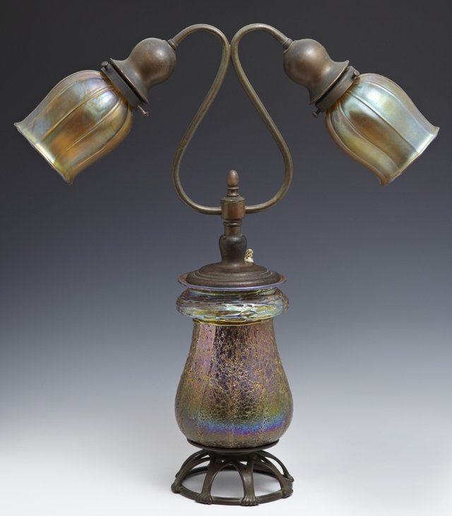 Tiffany-Style Patinated Bronze and Glass Two-Light: Tiffany-Style Patinated Bronze and Glass Two-Light Table Lamp, ca. 1900, the iridescent threaded glass center on a bronze base stamped "Tiffany Studios/ New York/ 574" underneath, with Favrille glass 