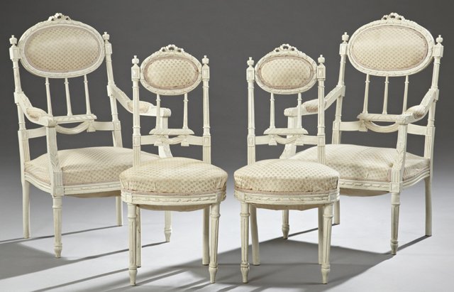 Set of Four Louis XVI Style Carved Beech Parlor Chairs,: Louis XVI Style Carved Beech Partial Parlor Suite, early 20th c., consisting of a pair of fauteuils and a pair of side chairs, all with bow form crests over upholstered backs on reeded spindled suppor