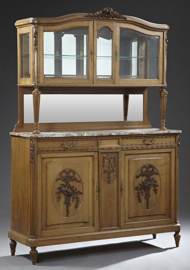 Louis XVI Style Carved Walnut Marble Top Buffet a Deux: Louis XVI Style Carved Walnut Marble Top Buffet a Deux Corps, 20th c., the upper section with an arched cornice above two beveled glazed cabinet doors on reeded tapered supports, above a highly figure