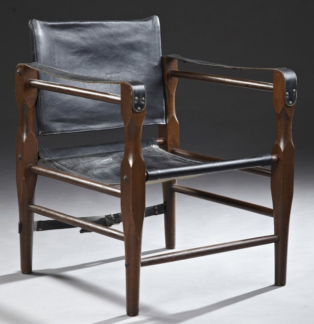 Mid Century Modern Carved Beech Leather Lounge Chair,: Mid Century Modern Carved Beech Leather Lounge Chair, mid 20th c., in the style of Arne Norell (1917-1971), the back tilting over a leather seat within leather strap arms, on tapered legs, joined by a