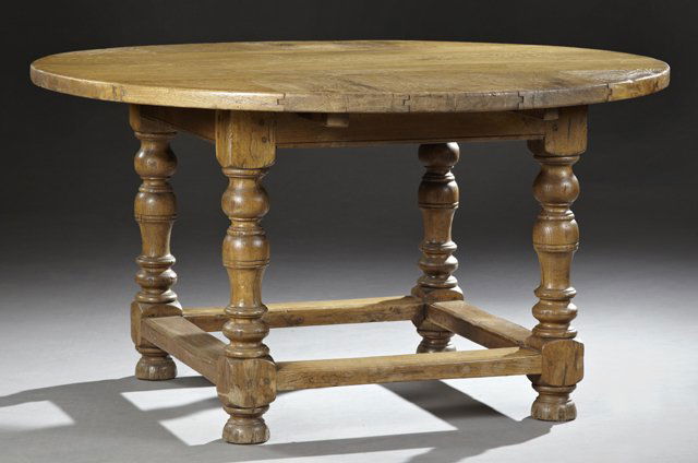 French Provincial Louis XIII Style Carved Oak Dining: French Provincial Louis XIII Style Carved Oak Dining Table, 19th c., the circular top over a wide apron, all on large turned legs, to flat ball feet, joined by a reeded box stretcher, H.- 30 in., Dia.
