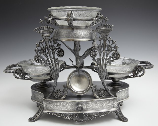 Unusual Meriden Silverplate Epergne, c. 1880, fitted: Unusual Meriden Silverplate Epergne, c. 1880, fitted for three glass bowls, over an eagle form pocket watch holder above a lower drawer, the whole on relief splayed legs, now with three associated pre