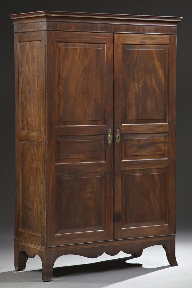 English Georgian Style Carved Mahogany Armoire, early: English Georgian Style Carved Mahogany Armoire, early 20th c., the banded inlaid stepped ogee crown above triple fielded panel double doors with gilt brass escutcheons, on splayed legs joined by a ser