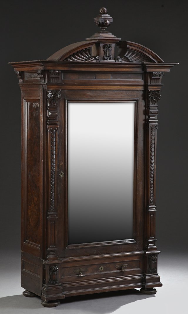 American Renaissance Revival Carved Mahogany and: American Renaissance Revival Carved Mahogany and Rosewood Armoire, late 19th c., the broken pediment cornice with a central reeded ball finial on a column, over a breakfront frieze and a single mirror