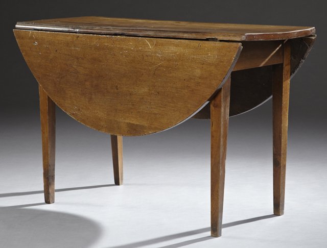 American Federal Style Carved Cherry and Mahogany Oval: American Federal Style Carved Cherry and Mahogany Oval Drop Leaf Table, 19th c., the three board top, over a wide apron, all on tapered square legs, Closed- H.- 29 in., W.- 19 1/2 in., D.- 48 1/4 in.,