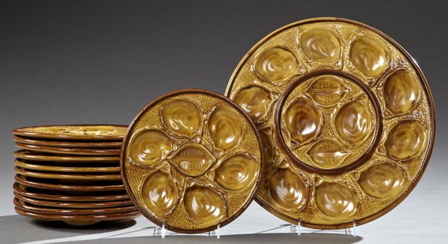 Thirteen Piece Majolica Oyster Set, 20th c., by St.: Thirteen Piece Majolica Oyster Set, 20th c., by St. Clement, consisting of a tray and twelve plates, Tray- Dia.- 15 in.