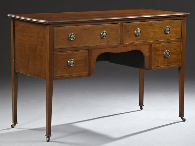 Edwardian Style Inlaid Carved Mahogany Kneehole Desk,: Edwardian Style Inlaid Carved Mahogany Kneehole Desk, early 20th c., the inlaid stepped edge top, over two frieze drawers and two short drawers with like inlay, all on tapered square legs to casters, 