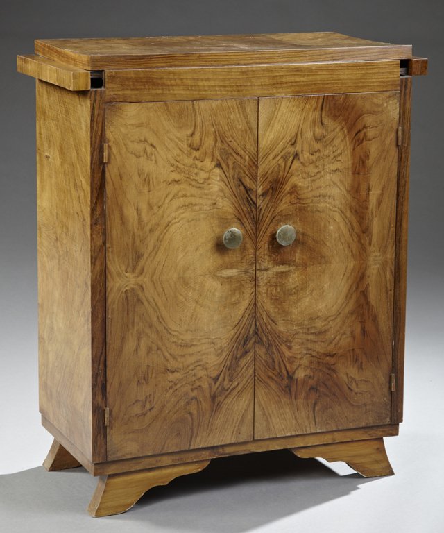 Diminutive Art Deco Style Figured Walnut Sideboard, c.: Diminutive Art Deco Style Figured Walnut Sideboard, c. 1940, the rectilinear top with expanding draw leaf sides, above two bookmatched figured walnut doors with brass hardware, the whole on bracket fe