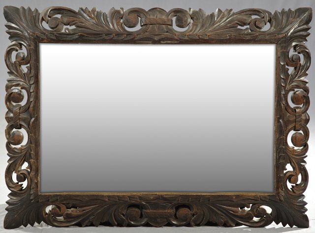 Jacobean Style Carved Beech Cushion Mirror, c. 1890,: Jacobean Style Carved Beech Cushion Mirror, c. 1890, with a pierced leaf carved frame over a beveled plate, H.- 43 in., W.- 31 in., D.- 3 in.