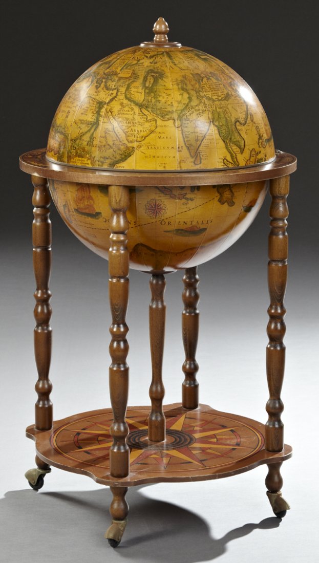 Terrestrial Globe Bar, 20th c., the top with an acorn: Terrestrial Globe Bar, 20th c., the top with an acorn finial, the globe with an antique map motif with rotating interior storage within a zodiac belt, over a nautical compass decorated stretcher shelf