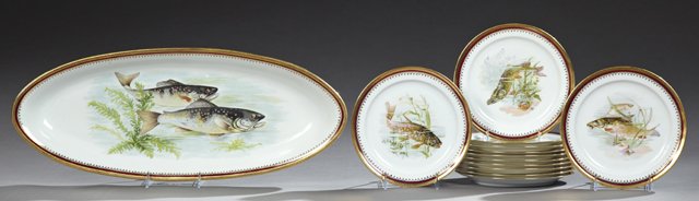 Thirteen Piece Limoges Porcelain Fish Set, early 20th: Thirteen Piece Limoges Porcelain Fish Set, early 20th c., consisting of a platter and twelve plates, with gilt decorated rims with magenta banding around central transfer reserves of fish, Platter- H.