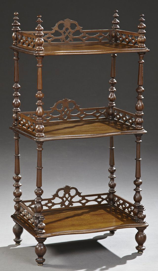 Victorian Classical Carved Mahogany Étagère, c. 1900: Victorian Classical Carved Mahogany Étagère, c. 1900, crowned by turned finials joining a pierced three-quarter gallery, surrounding a serpentine shelf, above two like shelves, all on turned tapered