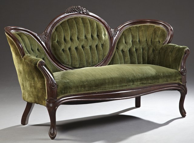 Late Victorian Carved Mahogany Medallion Back Settee,: Late Victorian Carved Mahogany Medallion Back Settee, c. 1900, the serpentine grape carved crest rail, over a tufted back with a central medallion, flanked by rolled arms, to a bowed seat, on cabriole