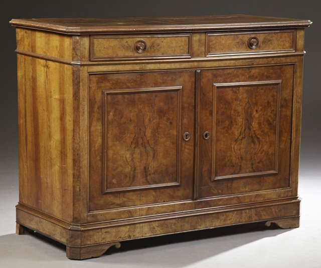 French Louis Philippe Carved Walnut and Cherry: French Louis Philippe Carved Walnut and Cherry Sideboard, c. 1850, Montmoreau, the canted corner stepped edge top over two frieze drawers, above double cupboard doors, flanked by chamfered stiles on a
