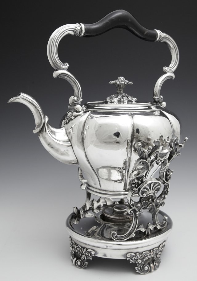 Continental Silverplate on Copper Hot Water Kettle on: Continental Silverplate on Copper Hot Water Kettle on Stand, 19th c., with an ebonized wood handle, the kettle of lobed form with a floriform lid handle, the base with relief supports, with alcohol bu