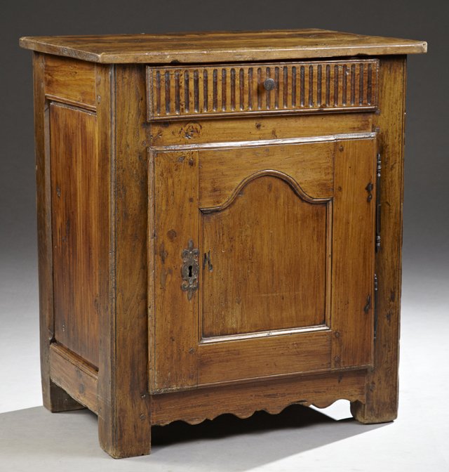 French Provincial Louis XV Style Carved Cherry: French Provincial Louis XV Style Carved Cherry Confiturier, 19th c., the top over a reeded frieze drawer above a single cupboard door with an iron fleur-de-lis form escutcheon and short iron fiche hin