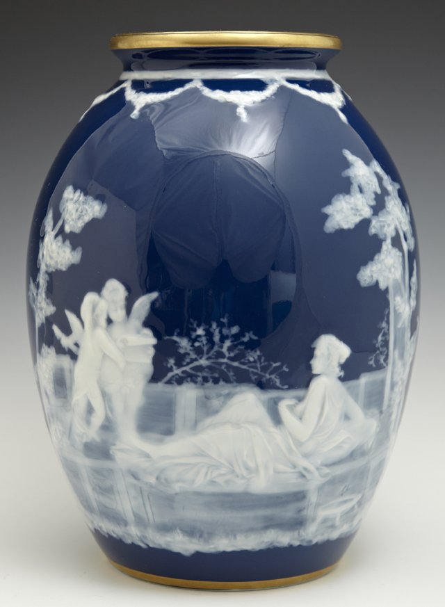 Limoges Pate Sur Pate Baluster Vase, 20th c., marked: Limoges Pate Sur Pate Baluster Vase, 20th c., marked "Barbotine de Marcel Haufriasse Porcelaines de Limoges," the side with putti decoration, on a cobalt blue ground, H.- 10 1/4 in., Dia.- 7 1/4 in.