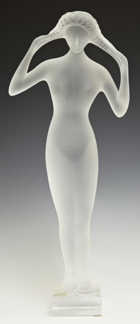 Lalique Frosted Glass Figure, 20th c., of a woman with: Lalique Frosted Glass Figure, 20th c., of a woman with braids, with an etched signature "Lalique, France," and a foil label, "Cristal Lalique, Paris," H.- 13 5/8 in., W.- 5 5/8 in., D.- 2 5/8 in.