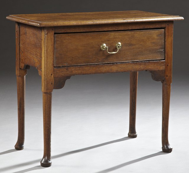 English George II Style Carved Oak Side Table, the: English George II Style Carved Oak Side Table, the stepped edge top over a deep drawer, above an ogee bracket decorated skirt, on tapered legs to pad feet, H- 28 1/4 in., W.- 31 1/2 in., D.- 17 1/4 in
