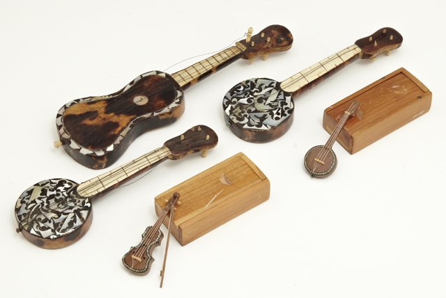 Group of Five Anglo Indian Mother-of-Pearl Inlaid: Group of Five Anglo Indian Mother-of-Pearl Inlaid Miniature Instruments, 19th c., three of tortoise shell, two in original carved wooden boxes, consisting of three banjos, a violin, and a guitar. (5 P