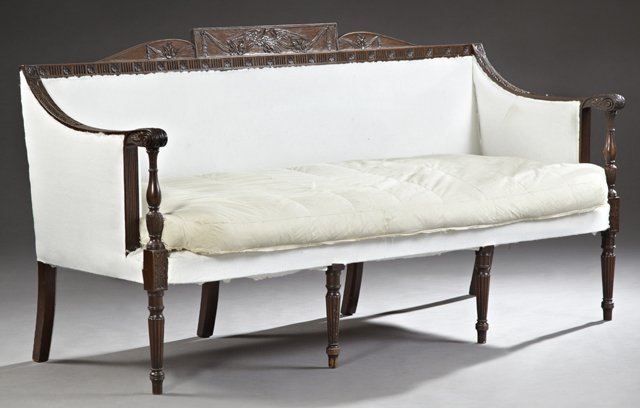 American Sheraton Style Carved Mahogany Sofa, 19th c.,: American Sheraton Style Carved Mahogany Sofa, 19th c., the carved swag and flower tablet crest rail above a long single cushion bench seat, within reeded scrolled arms, to baluster form supports, on r