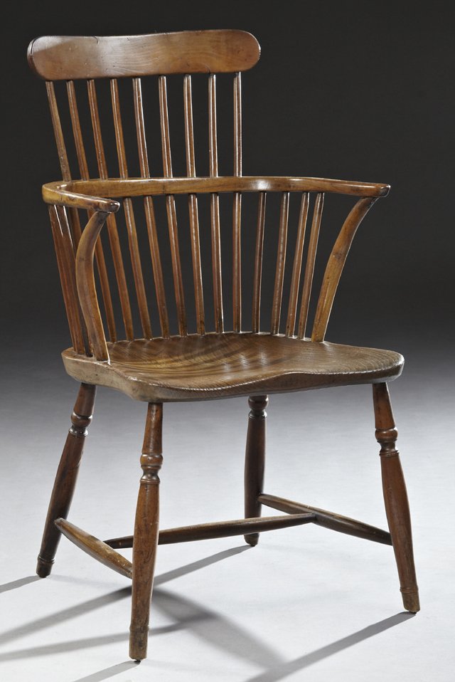 Windsor Style Comb Back Carved Oak Armchair, 19th c.,: Windsor Style Comb Back Carved Oak Armchair, 19th c., similar to the Oxford Bodleian Library chairs, the oval comb crestrail over curved arms, to a saddle seat, on turned tapered legs, joined by an H-