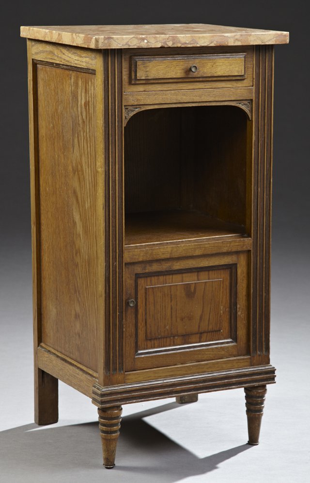 French Art Deco Carved Oak Marble Top Nightstand, c.: French Art Deco Carved Oak Marble Top Nightstand, c. 1920, the highly figured orange marble over a frieze drawer to an open shelf, above a pot cupboard with a tole lined interior, flanked by reeded st