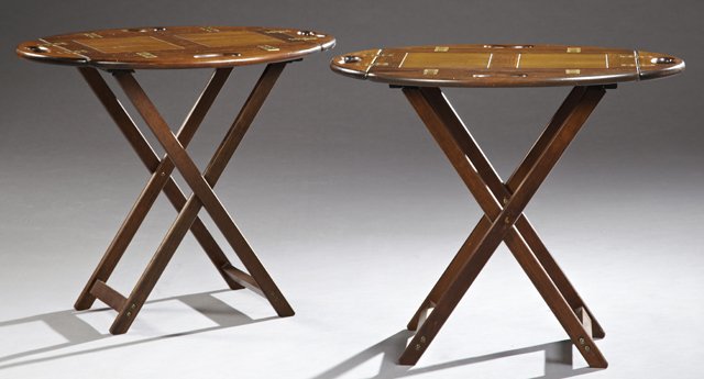 Pair of Chippendale Style Oval Carved Mahogany Butler's: Pair of Chippendale Style Oval Carved Mahogany Butler's Trays, 20th c., with pierced folding handles and brass hinges, on a folding base, H.- 24 in., W.- 28 in., D. 20 3/4 in.