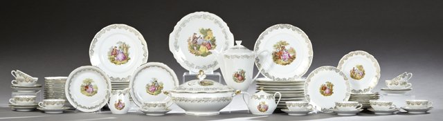 Seventy-Four Piece Set of Porcelain Dinnerware, early: Seventy-Four Piece Set of Porcelain Dinnerware, early 20th c., with gilt rims and gilt tracery banding, with central transfer reserves of lovers in a garden, consisting of 12 dinner plates, 11 soup bo