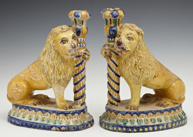 Rare Pair of French Tin Glazed Polychromed Earthenware: Rare Pair of French Tin Glazed Polychromed Earthenware Standing Lion Candlesticks, early 19th c., of left and right form with a bead decorated oval base, H.- 9 1/2 in., W.- 7 3/4 in., D.- 4 1/4 in.