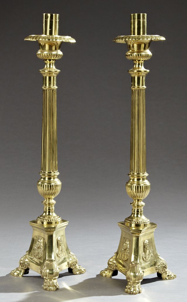 Pair of Italian Lacquered Brass Altar Candlesticks, in: Pair of Italian Lacquered Brass Altar Candlesticks, in the neoclassical taste, each with a fluted and bulbous standard above a tripodal base with panels depicting the Savior, the Virgin and the Sacred