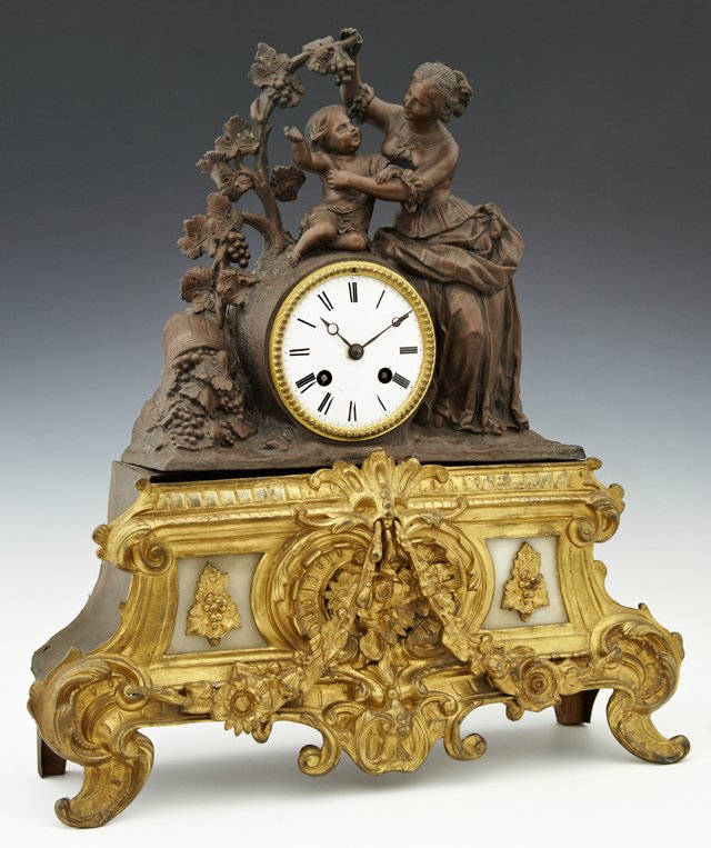 French Patinated Spelter, Brass and Alabaster Figural: French Patinated Spelter, Brass and Alabaster Figural Mantel Clock, c. 1870, by Japy Freres, the enamel dial drum clock surmounted by a patinated spelter figural group of a mother and child beneath a