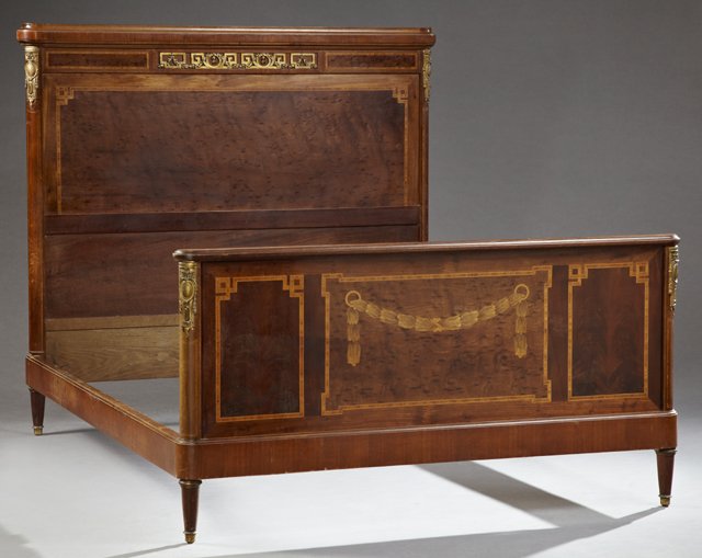 French Louis XV Style Inlaid Mahogany Ormolu Mounted: French Louis XV Style Inlaid Mahogany Ormolu Mounted Double Bed, c. 1900, the headboard with a shaped crest over an ormolu frieze, above an inlaid panel, the foot with an inlaid leaf garland, the whol