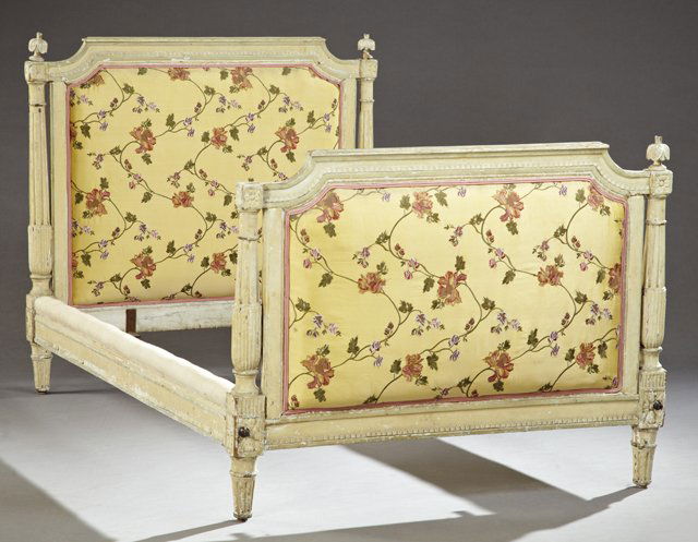 French Louis XVI Style Polychrome and Gesso Carved: French Louis XVI Style Polychrome and Gesso Carved Beech Single Bed, 19th c., the stepped carved headboard to tapered reeded legs, the footboard of like configuration, now upholstered in embroidered y
