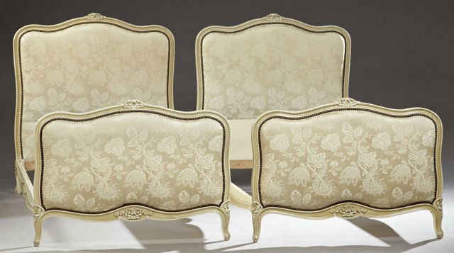 Pair of French Louis XV Style Polychromed Beds, early: Pair of French Louis XV Style Polychromed Beds, early 20th c., the serpentine carved arched headboard and footboard with an upholstered interior, on floral carved cabriole legs to scrolled toes, joine