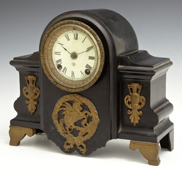 Ansonia Cast Iron French Style Mantel Clock, c. 1900,: Ansonia Cast Iron French Style Mantel Clock, c. 1900, time and strike, the arched center with an enamel dial over a gilt iron applique of Pegasus, flanked by setback sides with gilt iron urn mounts, H