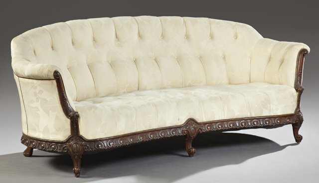 American Carved Mahogany Tufted Canape, early 20th c.,: American Carved Mahogany Tufted Canape, early 20th c., the curved tufted back over a kidney shaped tufted bench seat within rolled arms, to carved knees on cabriole legs to scrolled toes, joined by an