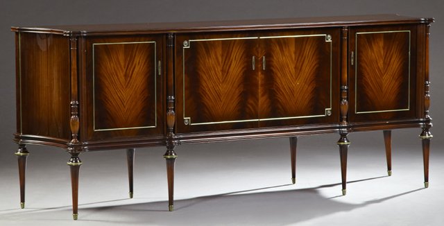 French Regency Style Carved Mahogany Sideboard, 20th: French Regency Style Carved Mahogany Sideboard, 20th c., the shaped top over central double cupboard doors flanked by cupboard doors and ring turned urn form columns, to concave sides, over a reeded s