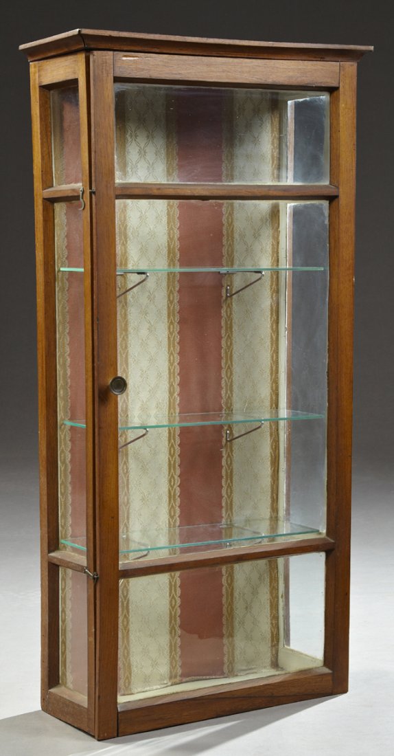 Carved Mahogany Hanging Display Cabinet, early 20th c.,: Carved Mahogany Hanging Display Cabinet, early 20th c., the ogee crown over a three panel glazed cupboard door, flanked by glazed sides, the interior fitted for three shelves, H.- 38 1/8 in., W.- 19 i