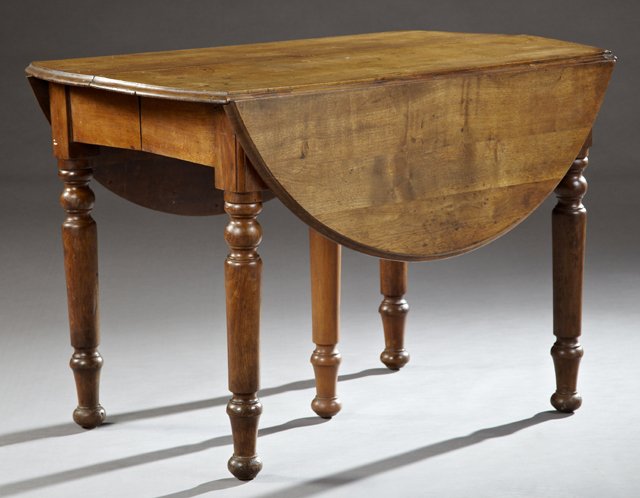 American Carved Walnut Drop Leaf Dining Table, 19th c.,: American Carved Walnut Drop Leaf Dining Table, 19th c., the oval top over a wide skirt, on ring turned tapered legs to ball feet, leaves now lacking, Closed- H.- 28 in., W.- 25 1/2 in., D.- 41 1/2 in.