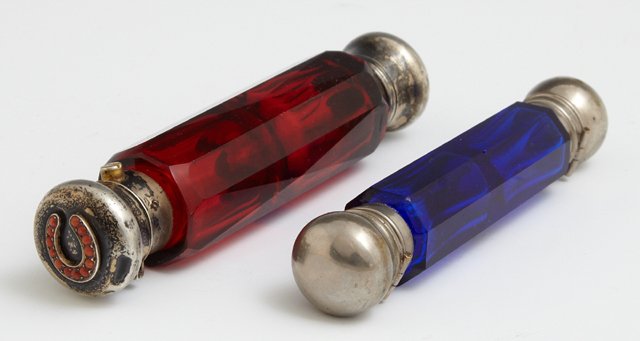 Two English Victorian Double Ended Octagonal Glass: Two English Victorian Double Ended Octagonal Glass Scent Bottles, c. 1880, one of ruby glass, one lid with a carnelian studded horseshoe, the other of cobalt glass, Ruby- Dia.- 1 1/8 in., W.- 5 1/4 in