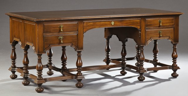 Edwardian Carved Mahogany Jacobean Style Partner's: Edwardian Carved Mahogany Jacobean Style Partner's Desk, c. 1910, the stepped edge rectangular top over a central frieze drawer, flanked by two short drawers on each side, the other side of like confi