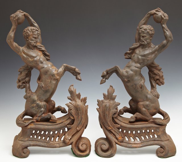 Unusual Pair of Cast Iron Andirons, 19th c., of: Unusual Pair of Cast Iron Andirons, 19th c., of centaurs holding orbs, on pierced scrolling bases, H.- 16 3/4 in., W.- 9 1/4 in., D.- 4 in.