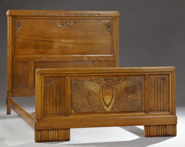 French Art Deco Carved Mahogany Bed, c. 1930, the: French Art Deco Carved Mahogany Bed, c. 1930, the stepped crown with a floral frieze over a floral carved fielded panel headboard, to a like footboard with a central floral carved panel flanked by flu