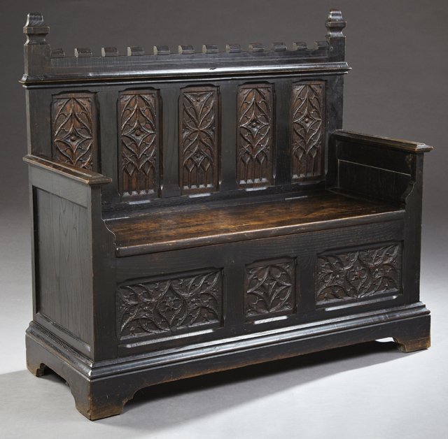 French Gothic Style Carved Oak Hall Bench, 19th c., the: French Gothic Style Carved Oak Hall Bench, 19th c., the stepped crest over an inset gothic style carved back above a lifting seat within carved arms, on an inset gothic style paneled base, to a steppe