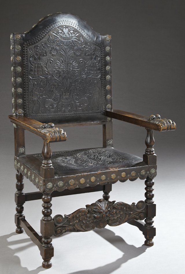 Spanish Renaissance Style Carved Birch Armchair, 19th: Spanish Renaissance Style Carved Birch Armchair, 19th c. the arched crest over a floral and figural embossed leather upholstered back above a square embossed leather seat with a decorative bronze flor