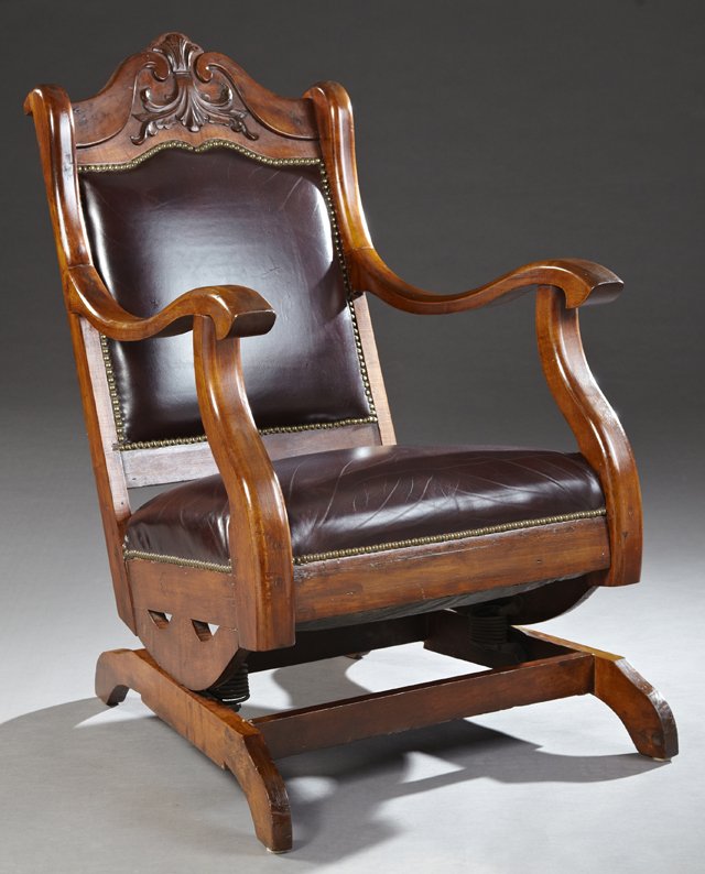 American Late Victorian Carved Mahogany Platform: American Late Victorian Carved Mahogany Platform Rocking Chair, Early 20th c., the arched crest over an arched square upholstered back, above a square seat within serpentine arms on a trestle platform