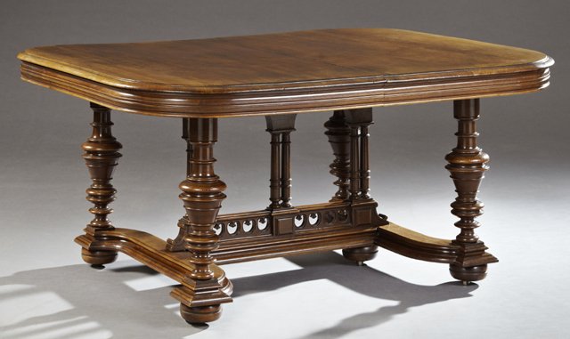 French Henri II Style Carved Walnut Dining Table, 19th: French Henri II Style Carved Walnut Dining Table, 19th c., the stepped curved corner rectangular top over a wide reeded skirt, on baluster ring turned supports to turned bun feet joined by an h-form s