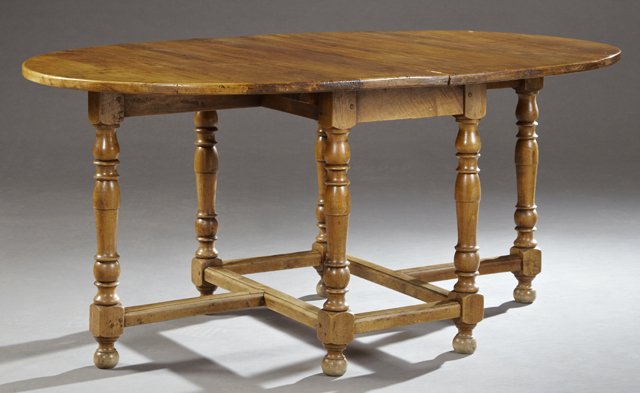 French Jacobean Style Carved Cherry Oval Dining Table,: French Jacobean Style Carved Cherry Oval Dining Table, early 20th c., the top opening for leaves, on tapered ring turned legs to bun feet, joined by reeded stretchers, now lacking the leaves, H.- 29 1